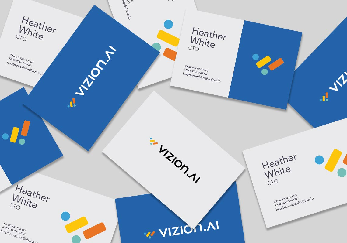 top down view of different vizionai business cards - presented are white and blue versions